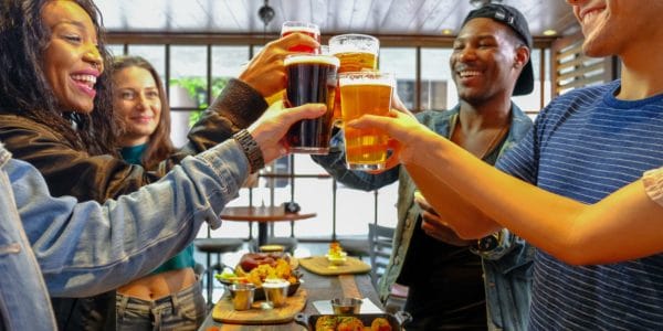 Group of friends cheering with beer at Public School 702