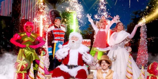 Father Christmas surrounded by his helpers